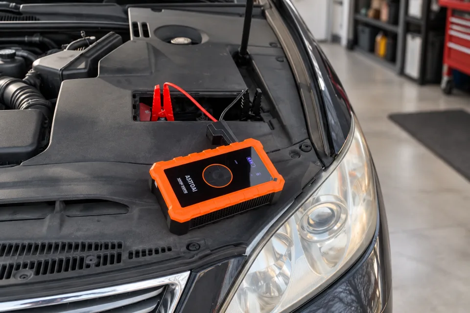 AstroAI S8 Air connected to a vehicle battery in a garage