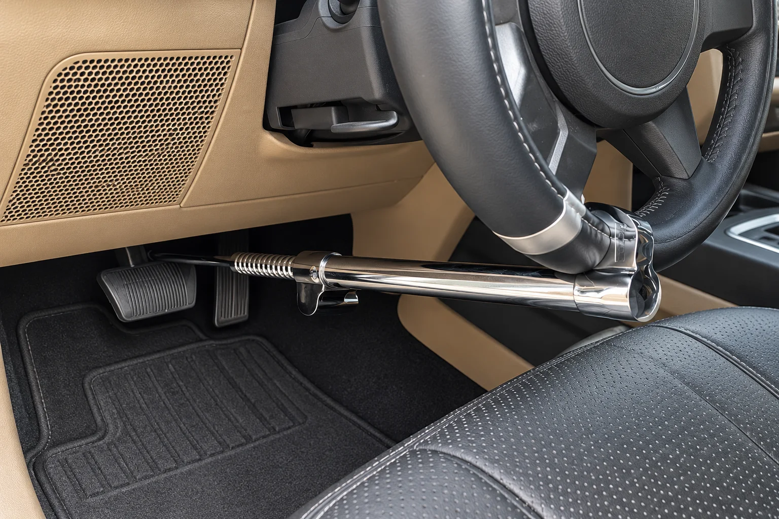 Chrome Tevlaphee lock connecting a steering wheel to a vehicle pedal
